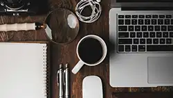 cup of coffee by laptop
