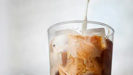 creamer pouring into coffee