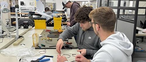 two students working on wire project