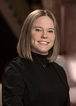 girl in business suit smiling at camera