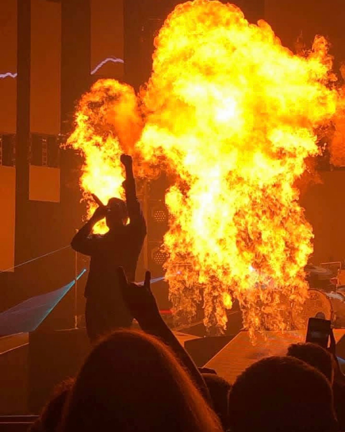 Brent standing with fire behind him