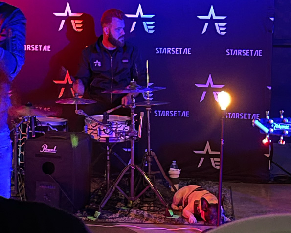 drummer with dog laying next to him