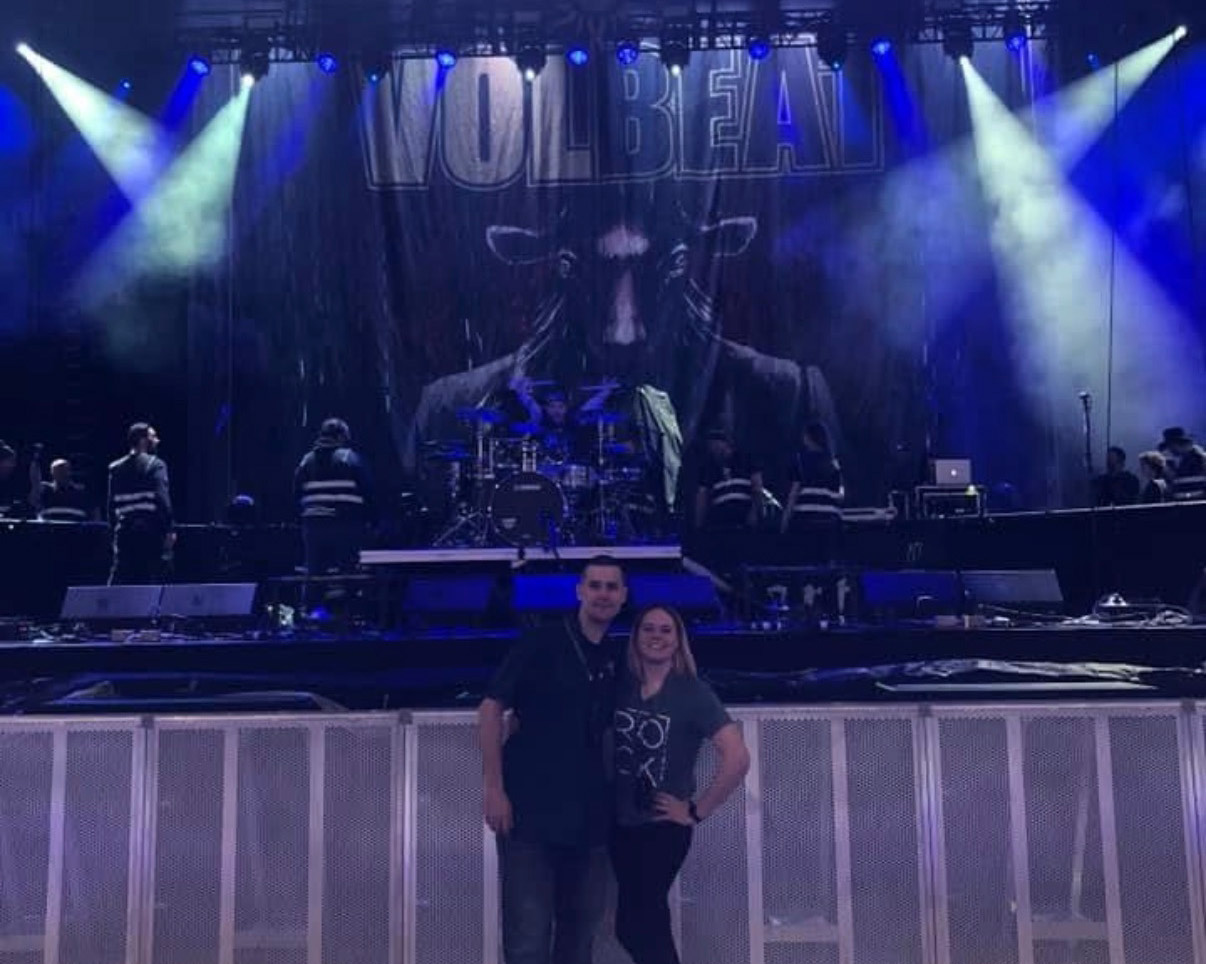 couple standing in front of concert stage